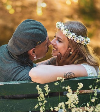 Brautpaar küsst sich auf einer Parkbank – Hochzeit von Tina & Will