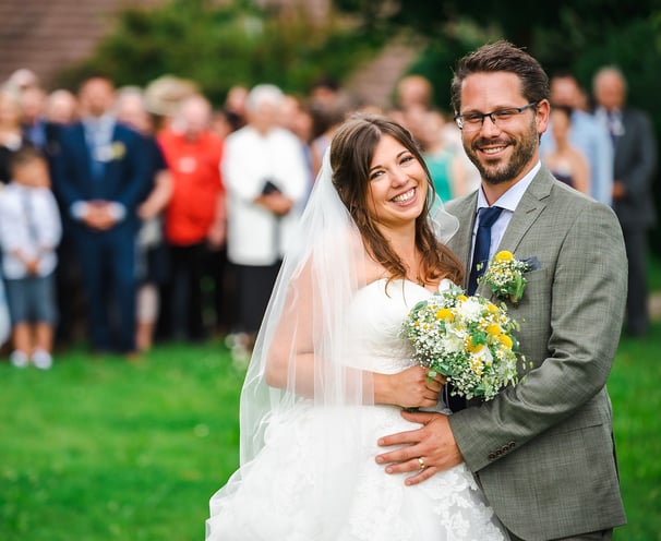Brautpaar umarmt sich vor den Hochzeitsgästen – Hochzeit von Misch & Simu